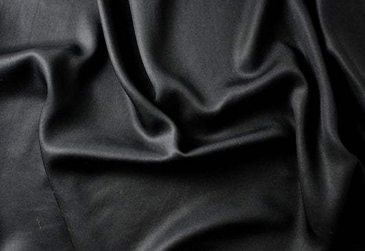 Black fabric draped softly —